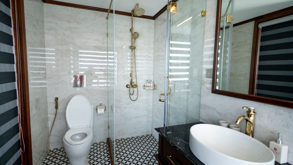 An example of classic bathroom designs in white and black marble with gold fixtures